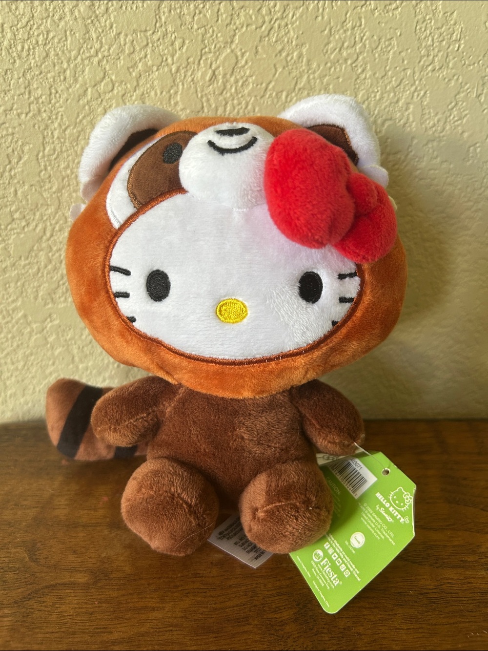 NWT Sanrio 2025 Hello Kitty Plush in Brown Raccoon Outfit with Red Bow
